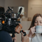 food and beverage video production featuring a caucasian woman with brown hair drinking out of a ceramic white mug with her eyes shut