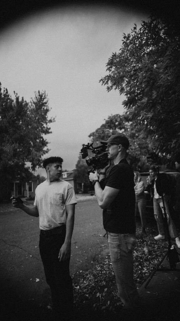 retail video production scene in process with two men. One with a camera